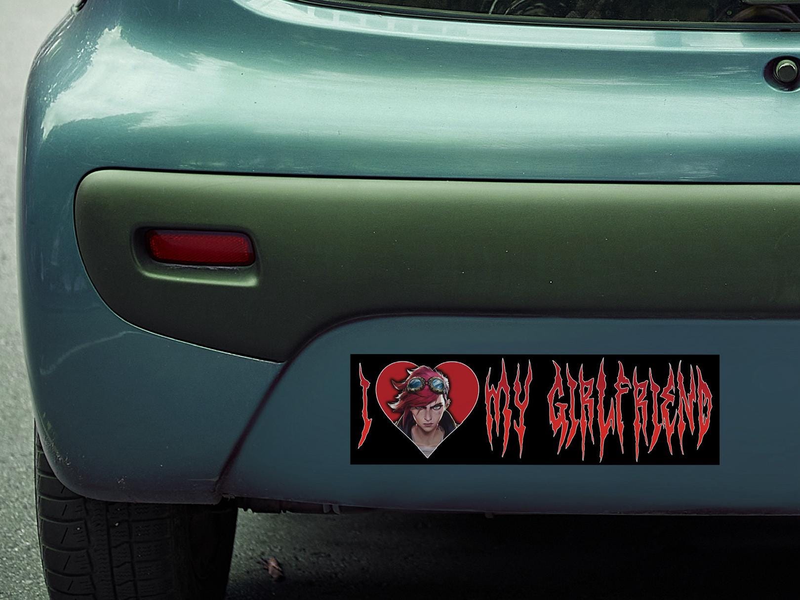 Bumper sticker with a graphic of vi from arcane and text 'I ❤️ my girlfriend' on a car's rear window.