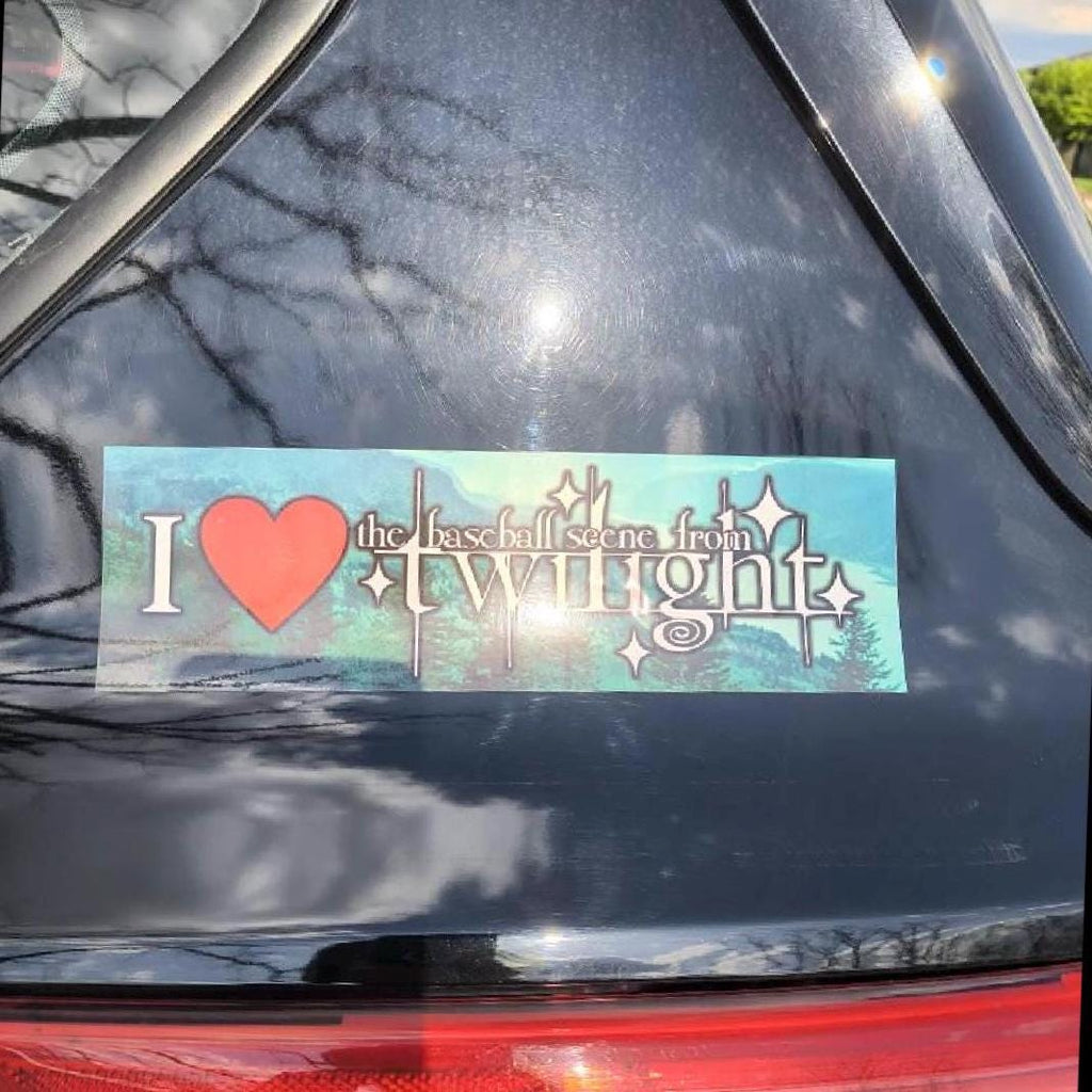 Bumper sticker with 'I ❤️ the baseball scene from twilight' on a car window.
