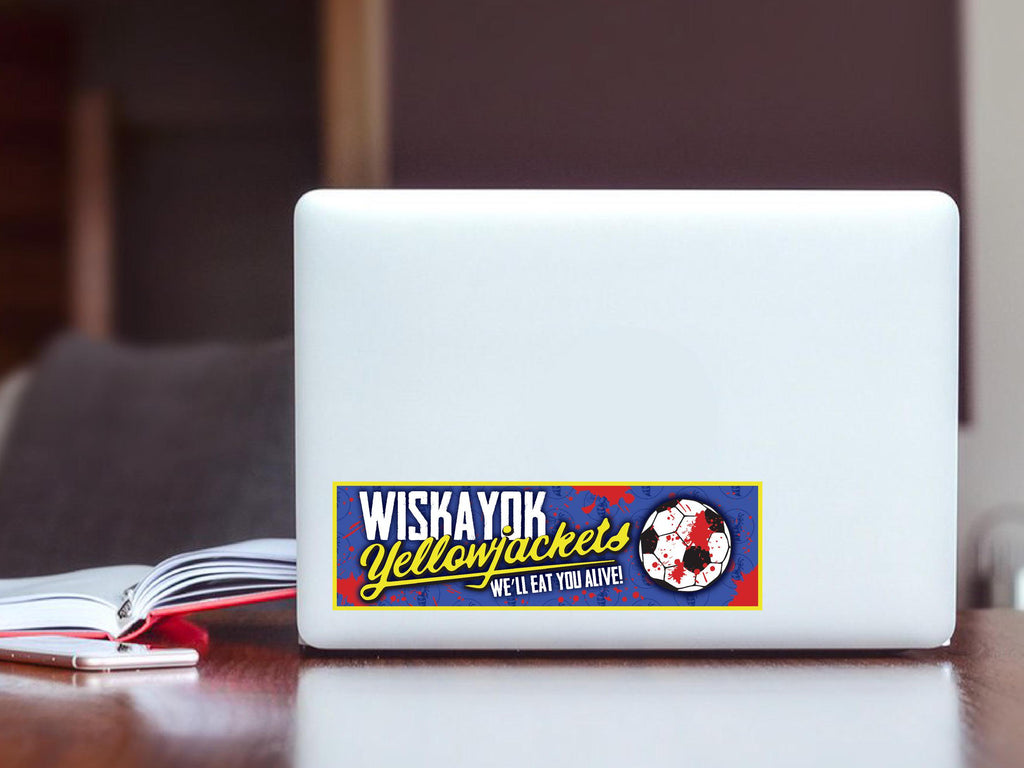 White laptop with a 'Wiskayok Yellowjackets' sticker on a wooden surface.