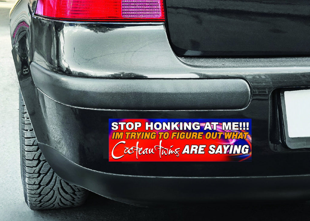 Bumper sticker on a car's rear bumper with humorous text