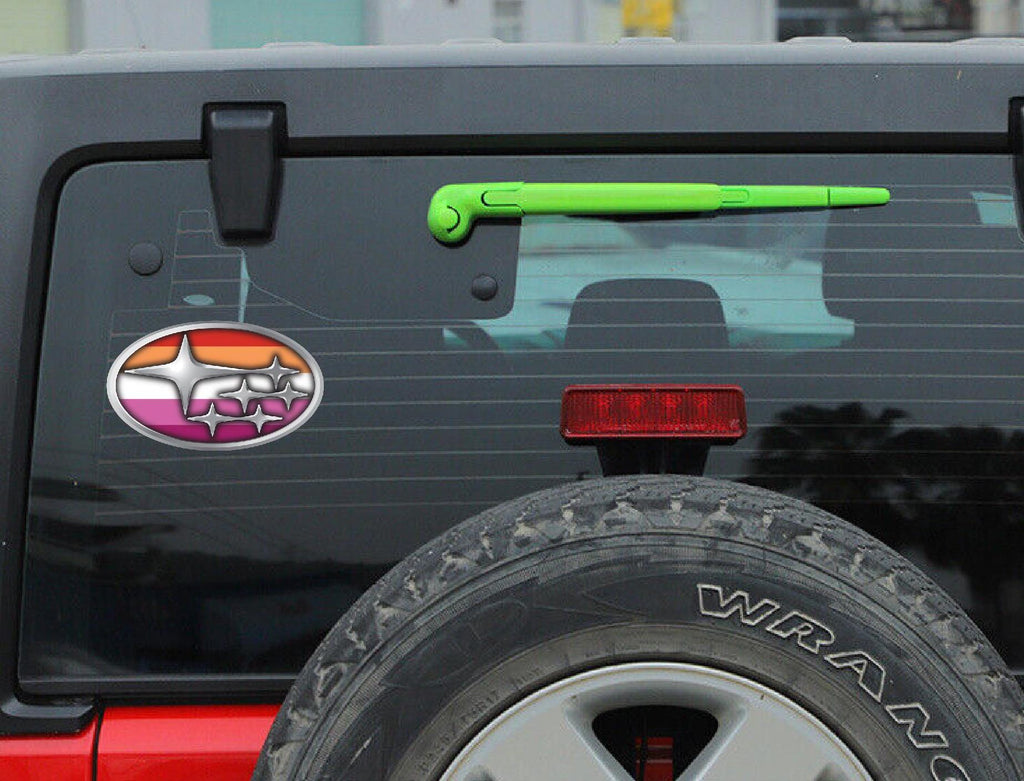 Back of a Jeep with a colorful decal on the tailgate.