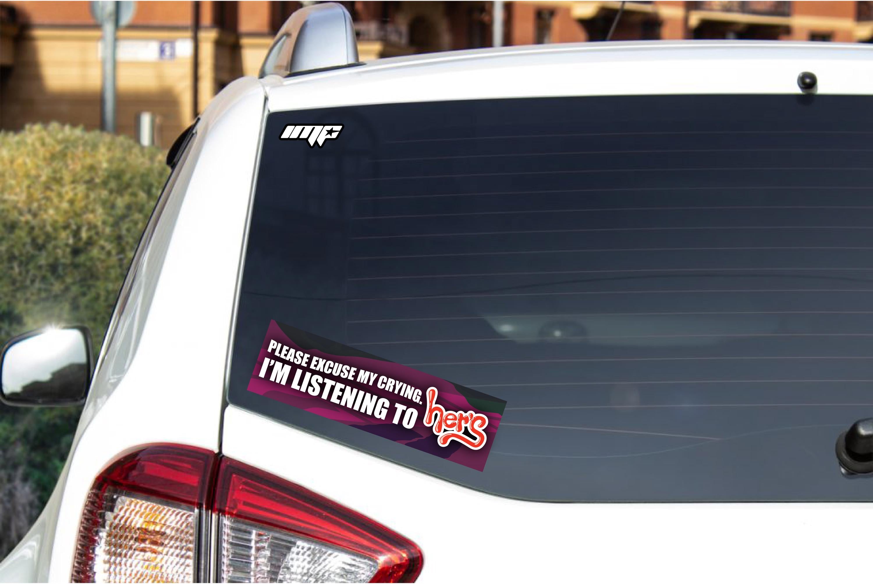 Car with a sticker on the rear window and another bumper sticker.