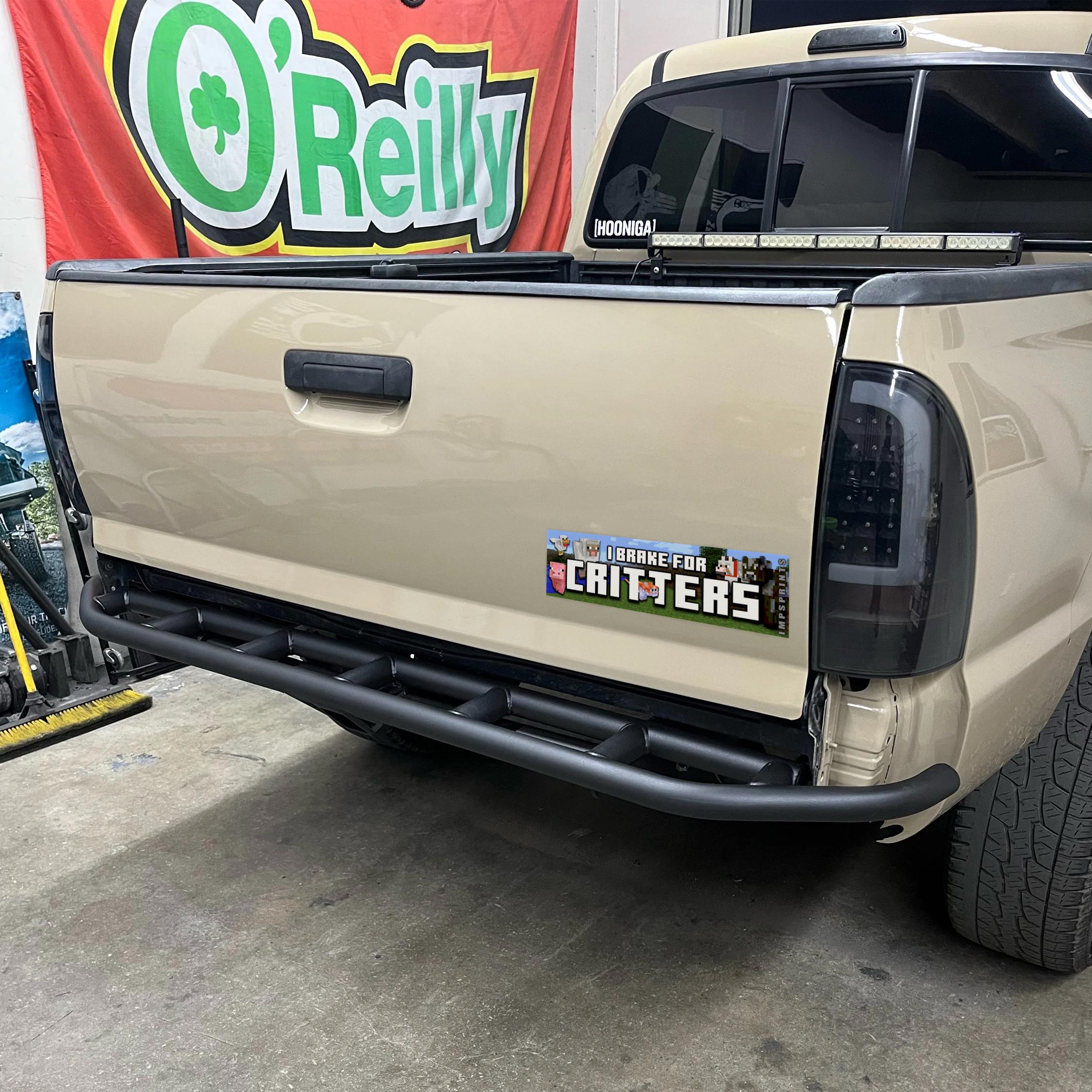 Beige truck with a black bumper in front of an O'Reilly Auto Parts sign.