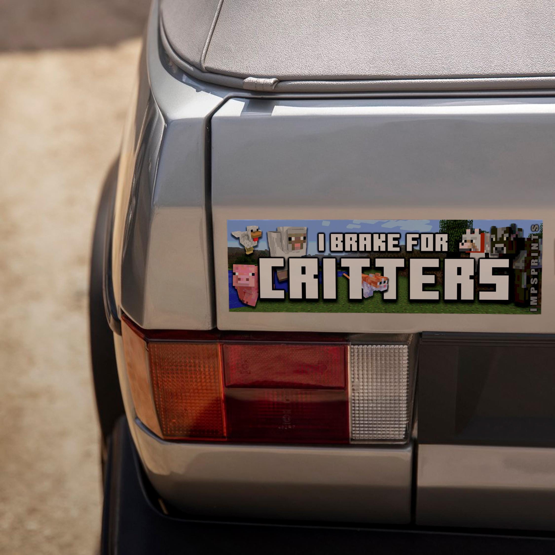 Car bumper with a 'I Brake for Critters' bumper sticker featuring cartoon animals.