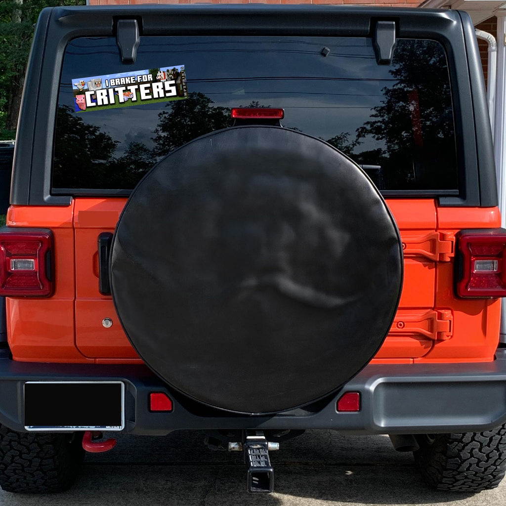 Orange Jeep with a black spare tire cover and 'Barbeque for Critters' sticker on the back window.