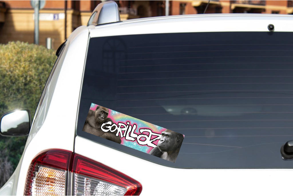 Car window with a 'Gorillaz' sticker on a white car