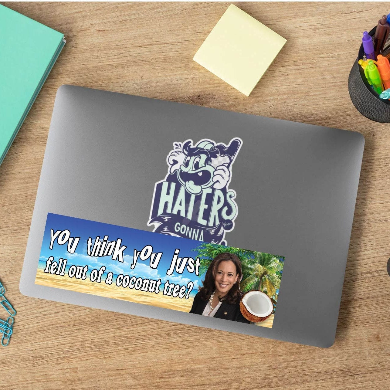 Gray laptop with a sticker on a wooden desk